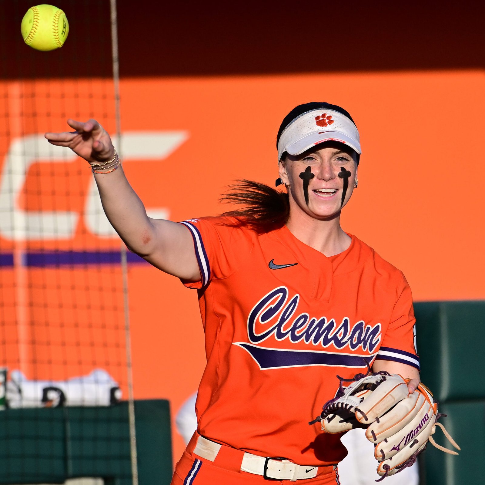 Marian Collins in an orange Clemson Softball uniform with Clemson script in purple.
