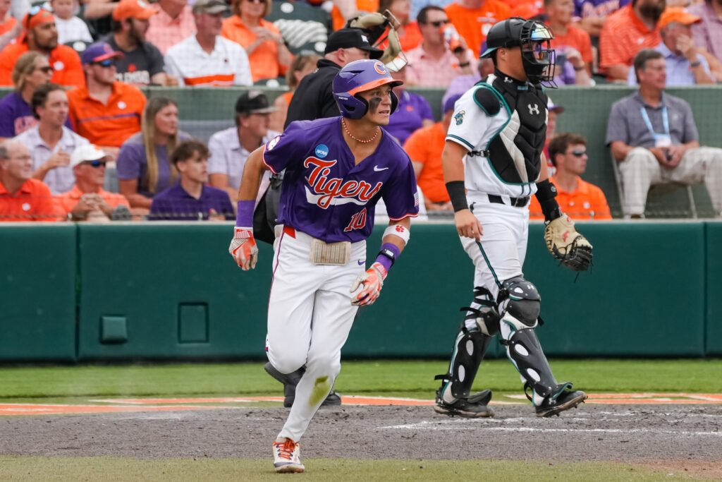 Cam Cannarella running to first base with a crowd watching in 2024 Clemson Regional.
