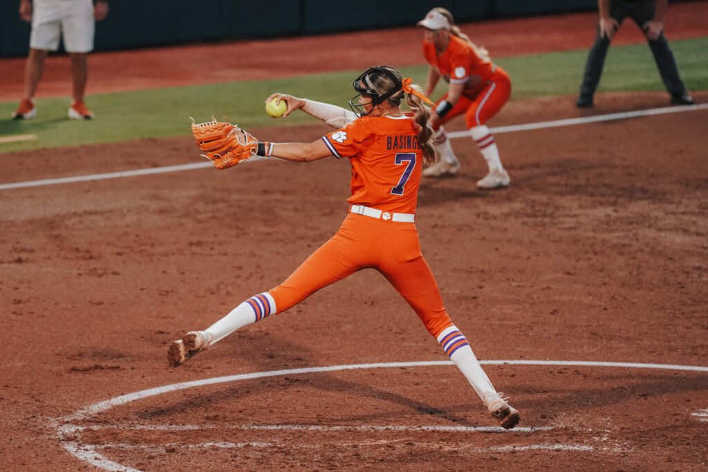 Clemson Tigers softball pitcher Reese Basinger in action, delivering a pitch on the field during a game. 